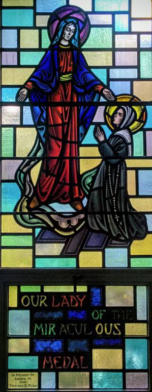 Part of a stained glass window depicting Our Lady of the Miraculous Medal
